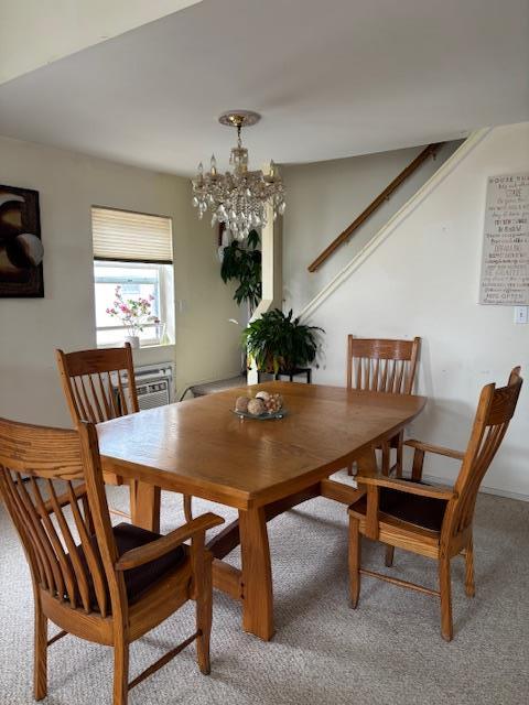 459 Monroe Blvd, Long Beach, NY 11561 - dining space featuring carpet floors, a chandelier, and stairway