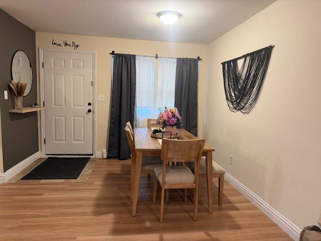459 Monroe Blvd, Long Beach, NY 11561 - dining area featuring light wood-style flooring and baseboards