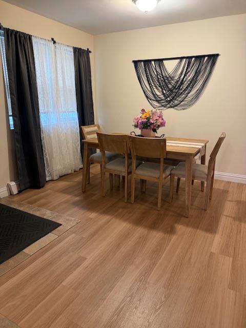 459 Monroe Blvd, Long Beach, NY 11561 - dining room with light wood-style flooring and baseboards