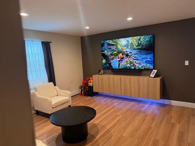 459 Monroe Blvd, Long Beach, NY 11561 - cinema with light wood-type flooring, recessed lighting, baseboards, and a baseboard radiator