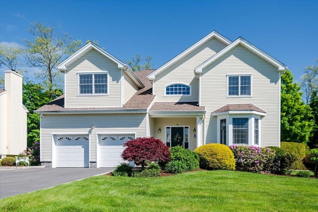 26 Hynard Pl, Baldwin Place, NY 10505 - view of front of house featuring asphalt driveway, a front lawn, and a shingled roof