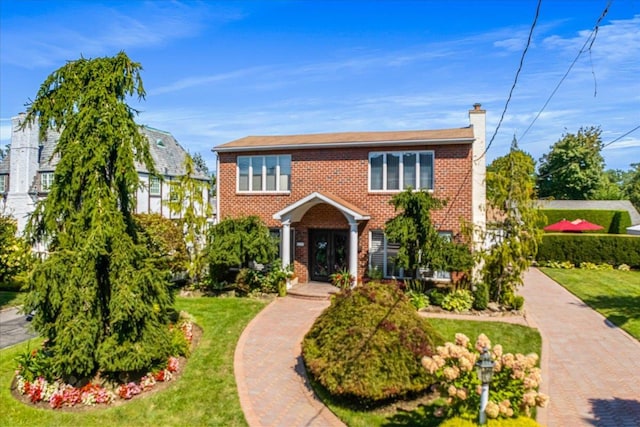 2957 214th Pl, Bayside, NY 11360 - view of front facade featuring brick siding, a chimney, and a front yard