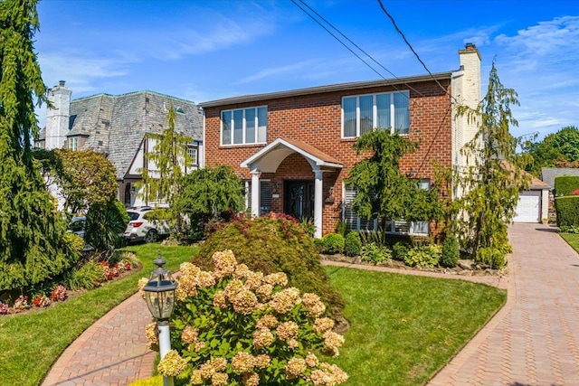 2957 214th Pl, Bayside, NY 11360 - view of front of property with a chimney, brick siding, a front lawn, and a garage