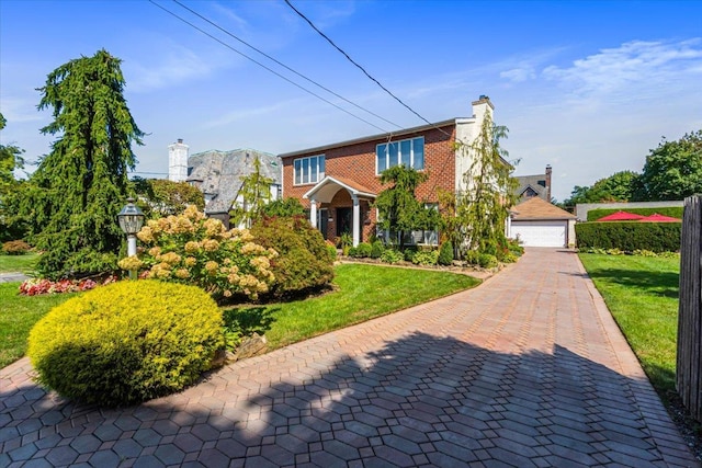 2957 214th Pl, Bayside, NY 11360 - view of front facade featuring brick siding, a detached garage, a front lawn, and a chimney