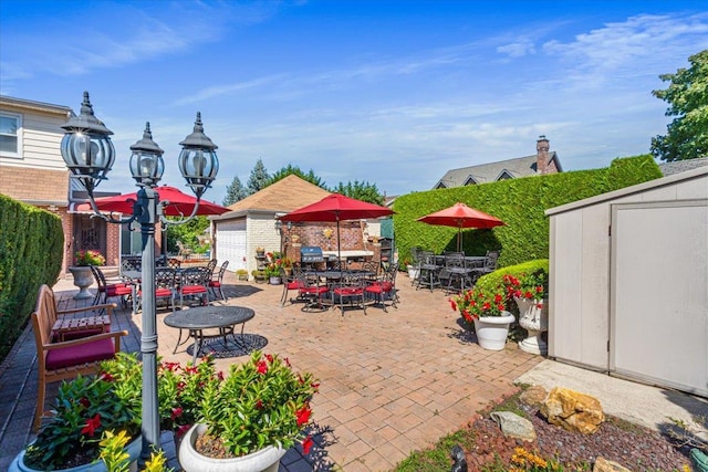 2957 214th Pl, Bayside, NY 11360 - view of patio / terrace with outdoor dining space, a storage shed, and an outbuilding