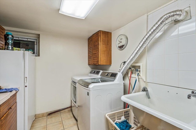 2957 214th Pl, Bayside, NY 11360 - clothes washing area with cabinet space, separate washer and dryer, and light tile patterned flooring
