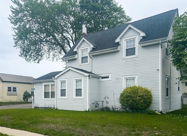 view of front of property featuring a chimney and a front yard
