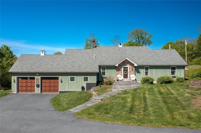 21 Big Elm Rd, Brewster, NY 10509 - view of front facade with driveway, a garage, a front yard, a chimney, and a shingled roof