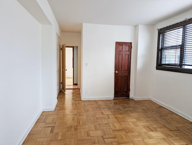 spare room featuring baseboards