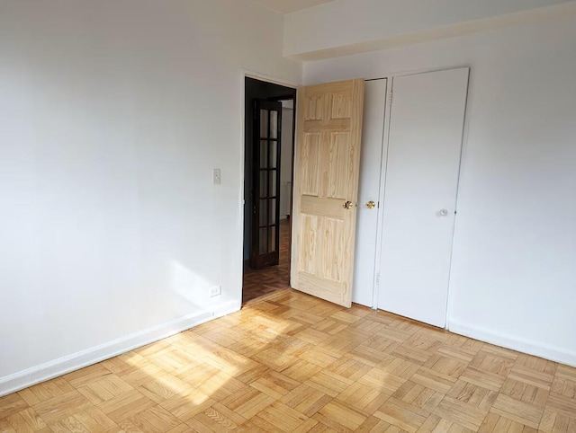 spare room with baseboards