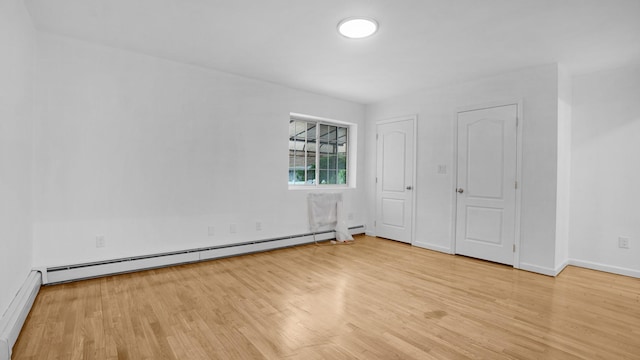 907 Clarence Ave, Bronx, NY 10465 - unfurnished bedroom featuring a baseboard heating unit, light wood-type flooring, baseboards, and a baseboard radiator
