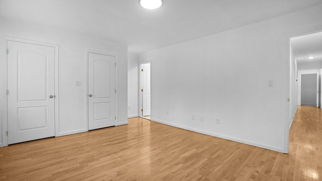 907 Clarence Ave, Bronx, NY 10465 - unfurnished bedroom with light wood-style flooring and baseboards