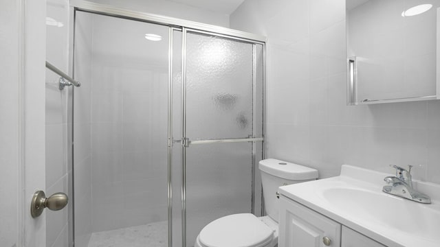 907 Clarence Ave, Bronx, NY 10465 - full bathroom with a shower stall, toilet, tile walls, and vanity