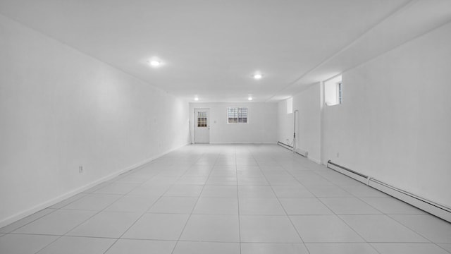 907 Clarence Ave, Bronx, NY 10465 - basement with a baseboard radiator, baseboard heating, recessed lighting, and light tile patterned floors