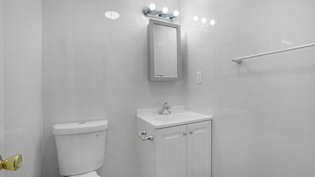 907 Clarence Ave, Bronx, NY 10465 - half bathroom with tile walls, toilet, and vanity