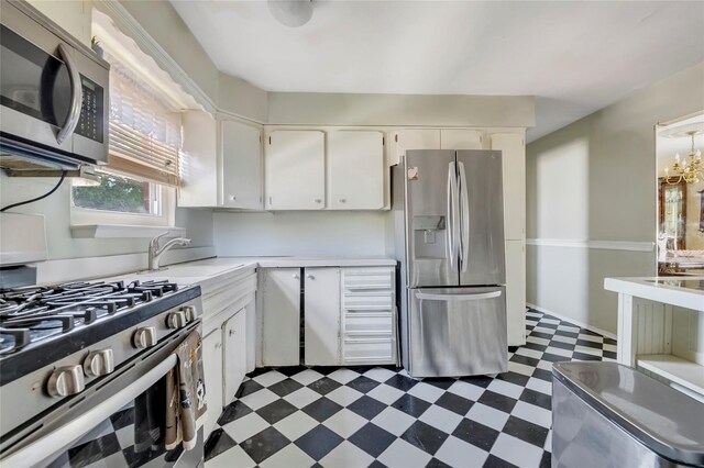 151-84 17th Rd, Whitestone, NY 11357 - kitchen with appliances with stainless steel finishes, dark flooring, light countertops, white cabinets, and a sink