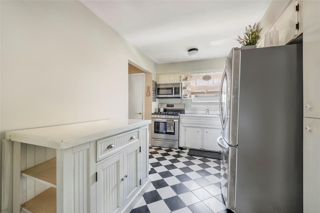 151-84 17th Rd, Whitestone, NY 11357 - kitchen with stainless steel appliances, tile patterned floors, open shelves, light countertops, and white cabinetry