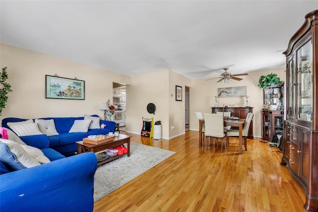 151-84 17th Rd, Whitestone, NY 11357 - living area with light wood-style flooring, a ceiling fan, and baseboards