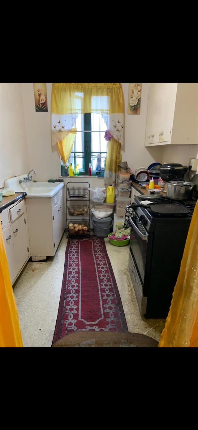 1314 Virginia Ave Unit 5A, Bronx, NY 10462 - kitchen with black range oven, white cabinets, light countertops, and a sink