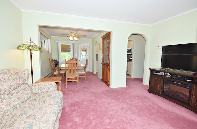 11 Cinque Dr, Farmingdale, NY 11735 - dining room featuring ornamental molding, light colored carpet, arched walkways, ceiling fan, and baseboards