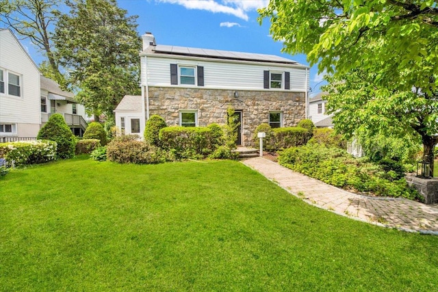 6 Mcbride Ave, White Plains, NY 10603 - traditional home with solar panels, a front yard, a chimney, and stone siding