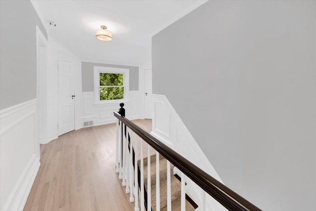 6 Mcbride Ave, White Plains, NY 10603 - hall featuring an upstairs landing, a decorative wall, light wood-style flooring, and wainscoting