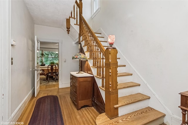 24 John St, Beacon, NY 12508 - stairway featuring wood finished floors