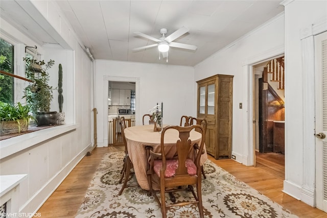 24 John St, Beacon, NY 12508 - dining space with light wood-type flooring, a ceiling fan, and crown molding