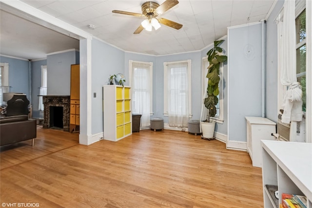 24 John St, Beacon, NY 12508 - living area featuring crown molding, plenty of natural light, light wood finished floors, ceiling fan, and baseboards
