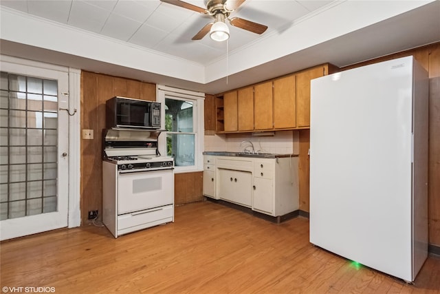 24 John St, Beacon, NY 12508 - kitchen featuring white appliances, light wood-style floors, ceiling fan, ornamental molding, and dark countertops