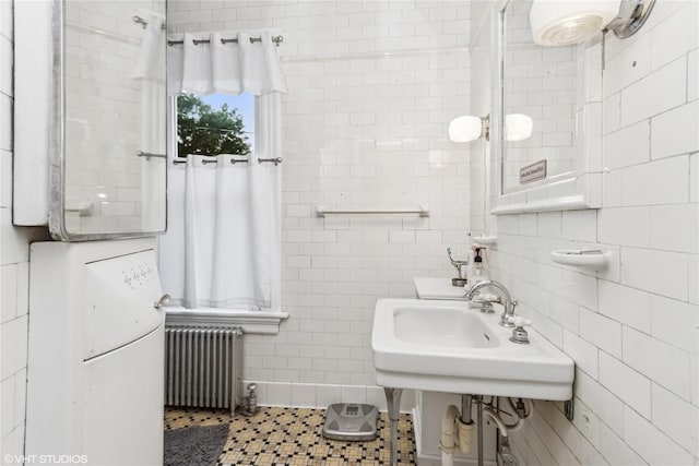 24 John St, Beacon, NY 12508 - bathroom with radiator, tile walls, tile patterned floors, and a sink