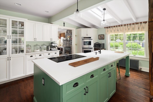 41 Granite Springs Rd, Granite Springs, NY 10527 - kitchen featuring black electric stovetop, green cabinetry, stainless steel double oven, white cabinets, and dark wood finished floors