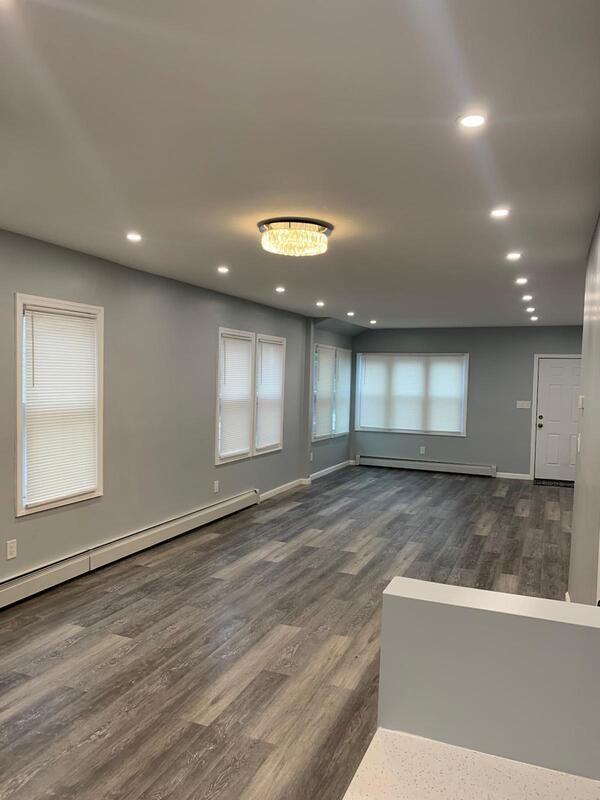 158-04 111th Ave, Jamaica, NY 11433 - empty room with a baseboard heating unit, dark wood finished floors, recessed lighting, and baseboards