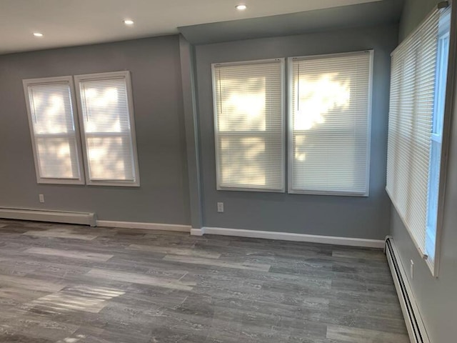 158-04 111th Ave, Jamaica, NY 11433 - spare room featuring a baseboard radiator, baseboard heating, wood finished floors, plenty of natural light, and recessed lighting