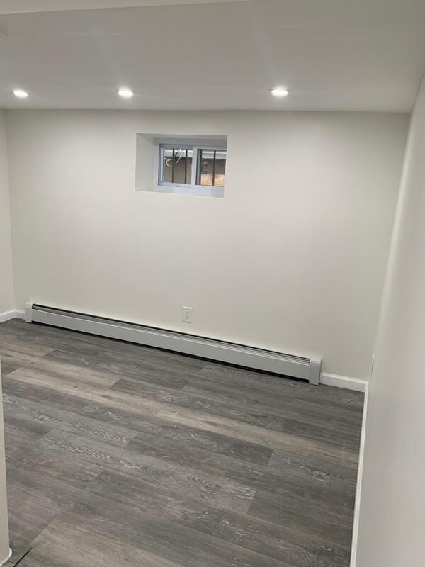 158-04 111th Ave, Jamaica, NY 11433 - spare room with baseboard heating, wood finished floors, baseboards, and recessed lighting