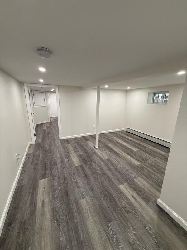 158-04 111th Ave, Jamaica, NY 11433 - finished below grade area featuring a baseboard radiator, wood finished floors, baseboards, and recessed lighting