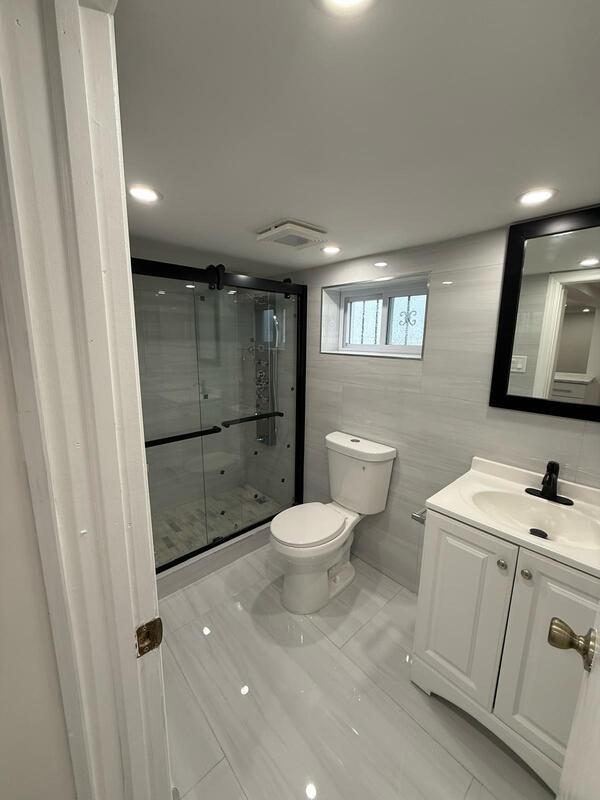 158-04 111th Ave, Jamaica, NY 11433 - full bathroom featuring toilet, a stall shower, vanity, tile walls, and recessed lighting