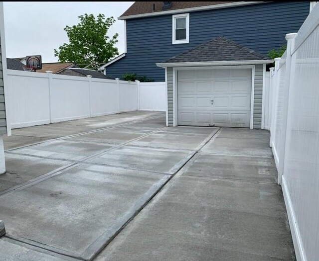 158-04 111th Ave, Jamaica, NY 11433 - garage featuring fence and driveway
