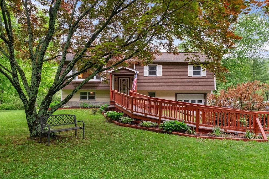 600 Sprout Brook Rd, Putnam Valley, NY 10579 - rear view of house with a garage, a wooden deck, and a yard
