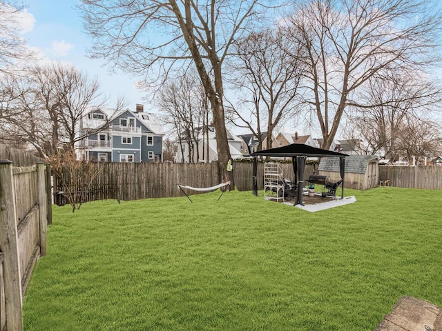 view of yard with a gazebo, an outbuilding, a patio, and a storage unit