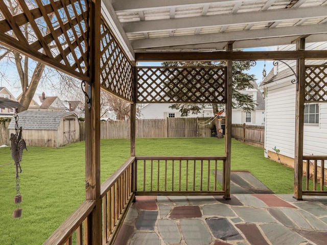 wooden deck with a storage shed, a pergola, an outbuilding, and a patio