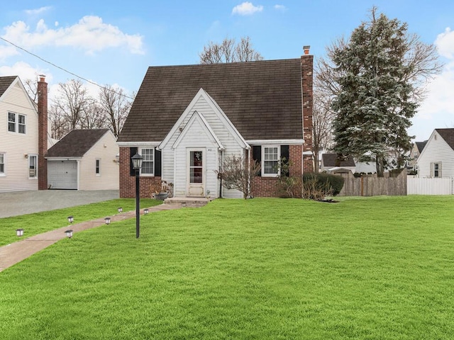 cape cod-style house featuring a garage, an outbuilding, brick siding, a chimney, and driveway