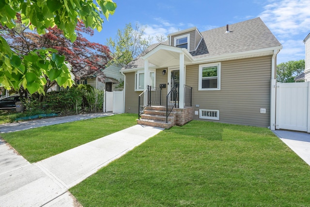 bungalow with a shingled roof and a gate