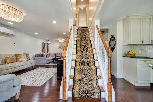 staircase featuring wood-type flooring, recessed lighting, ornamental molding, a wall unit AC, and a wall mounted AC
