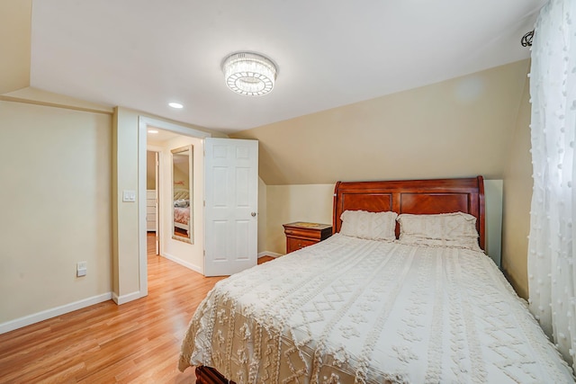 bedroom with light wood-style floors, vaulted ceiling, baseboards, and recessed lighting