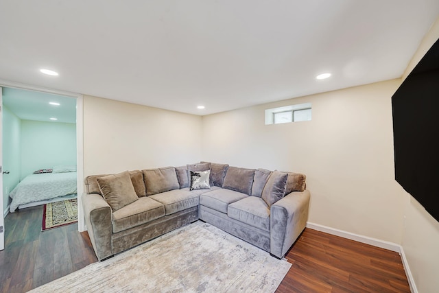 living room with wood finished floors, baseboards, and recessed lighting