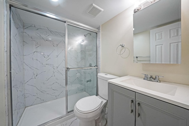 bathroom featuring toilet, marble finish flooring, and a marble finish shower