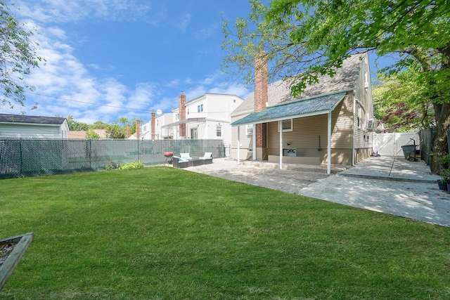 rear view of house with a patio area, a chimney, and a gate