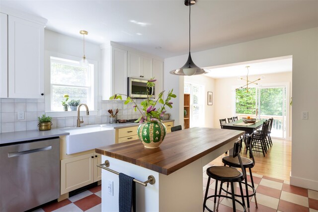 1531 Glasco Tpke, Saugerties, NY 12498 - kitchen featuring stainless steel appliances, butcher block countertops, a sink, backsplash, and light flooring