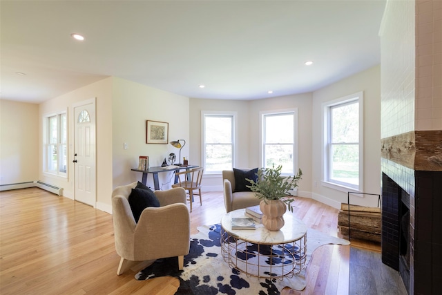 1531 Glasco Tpke, Saugerties, NY 12498 - living area with light wood-type flooring, a fireplace, a baseboard heating unit, recessed lighting, and baseboards